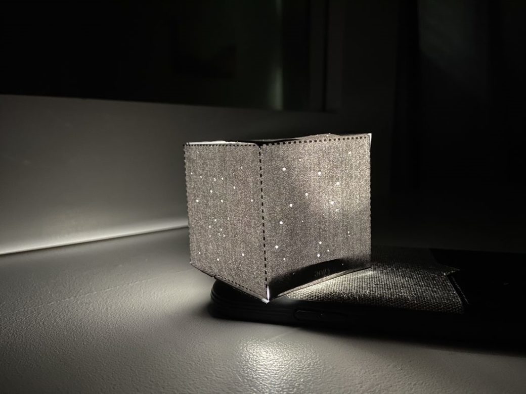A square object made of fabric with a light in the middle, creating the impression of a starry night sky