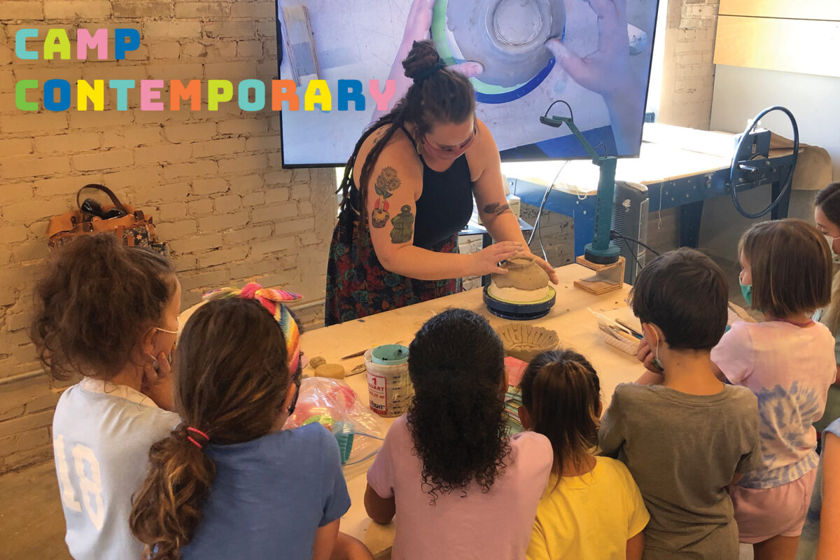 A group of children gather around an instructor demonstrating a technique with clay. Multicolor font in the upper left corner reads "Camp Contemporary."