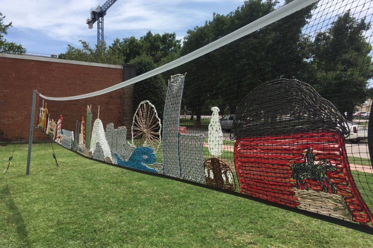 Oklahoma landmarks like the red barn and Devon Tower are embroidered on a volleyball net