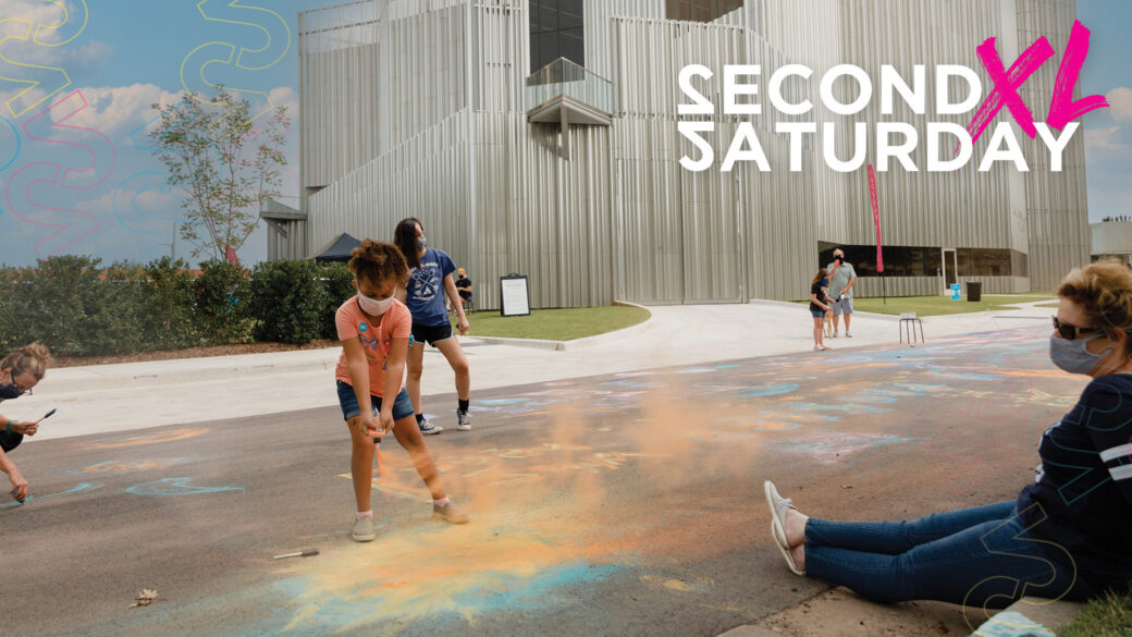 A little kid is playing with chalk outside, the orange dust blowing in the wind. Behind her is a blue sky with clouds, and graphic outlines of the number two in pinks and yellows. The logo Second Saturday XL is in the top right corner in white and pink.