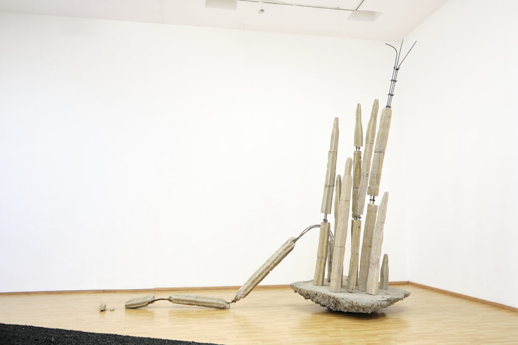 An abstract vertical sculpture made of industrial materials