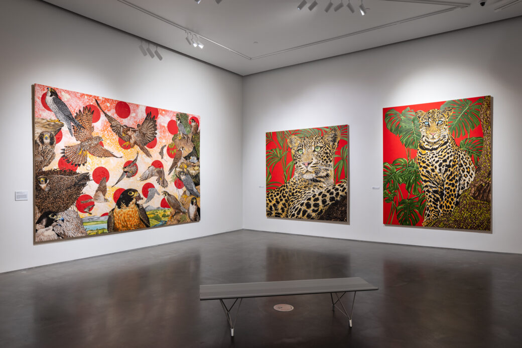 Three vibrant paintings of flora and fauna. The left features birds of prey, while the two on the right feature leopards.