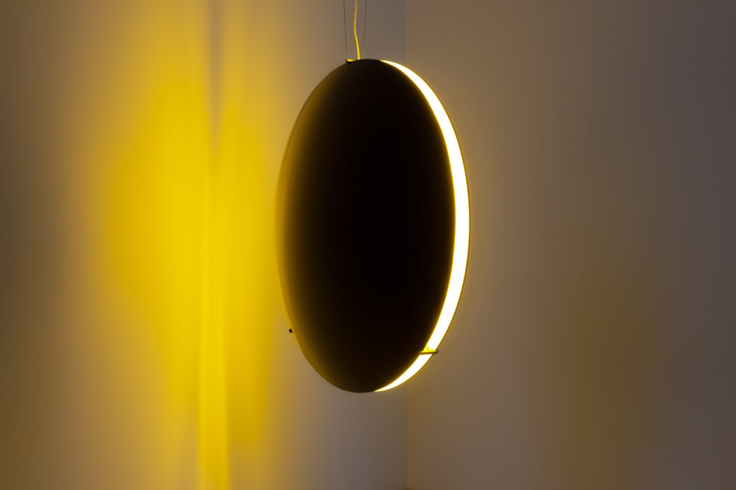 Image of a spherical light sculpture emitting a golden hue