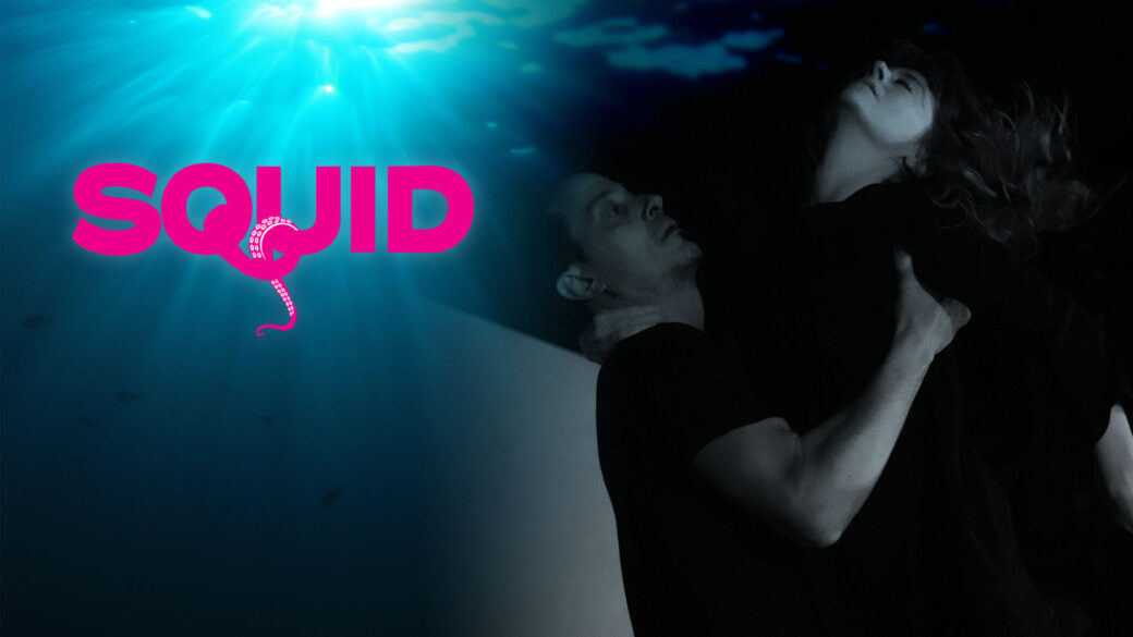 One dancer lifts another whose head is thrown back dramatically. The upper left corner shows light shining through the surface of water and a pink logo reading "SQUID."