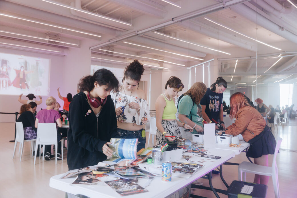 Several teens gather around a table for art-making activities