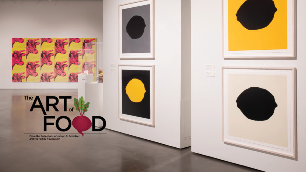 Several black, white, gray and yellow prints of lemons hang with a pink and yellow print of cows in the background. A logo in the lower left reads "The Art of Food: From the Collections of Jordan D. Schnitzer and His Family Foundation."