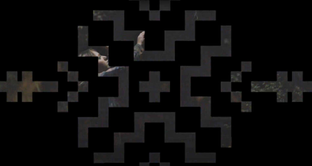 Geometric shapes form a grid-like mask across a photo of someone reaching up toward a tree. The image is dark. The shapes are black.