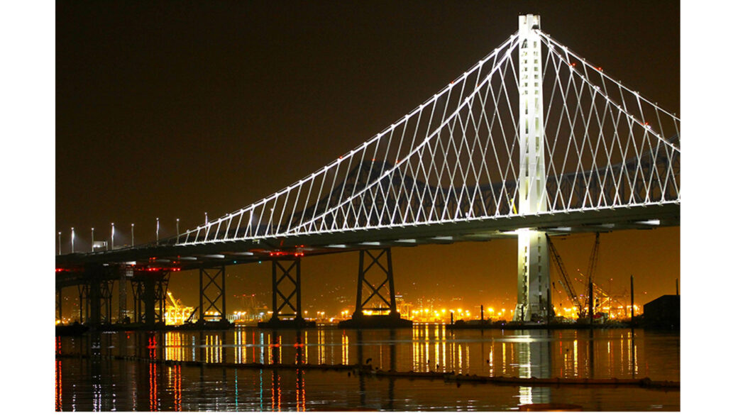 A suspension bridge illuminated at night