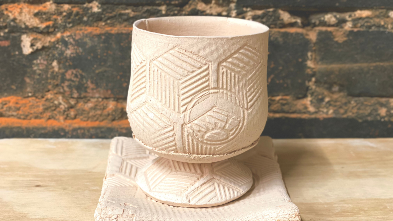 Unglazed ceramic cup and small plate