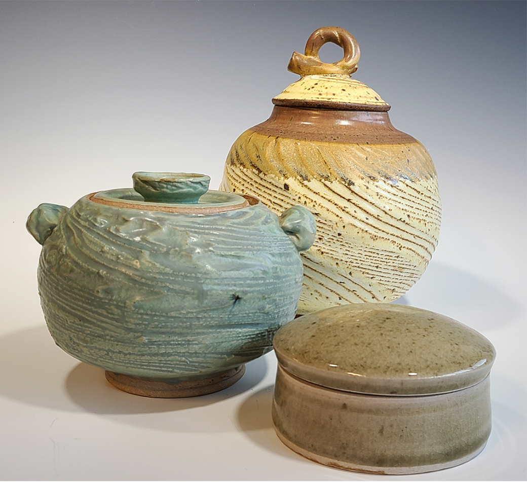Three lidded ceramics jars of various sizes