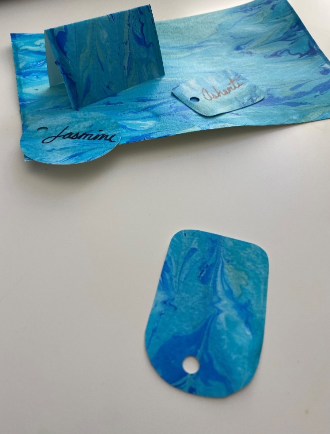 The same abstract blue artwork, along with name tags rendered in the same style and color