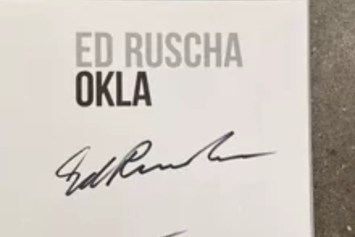 The corner a book page reads "ED RUSCHA OKLA" with a signature below the title