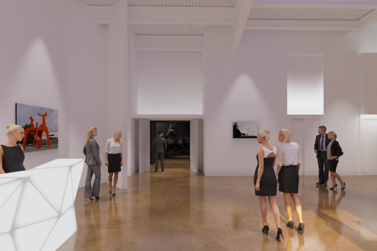 People walk through a white-walled lobby with art hanging up