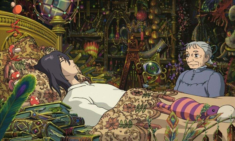 An animated person lays in bed, surrounded by shining and colorful trinkets. An elderly woman sits beside the bed.