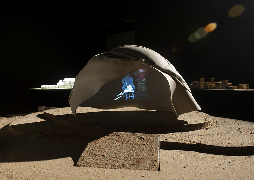 A tan dome tent with images of people projected inside