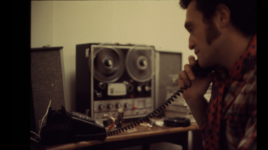 A person holds a phone to their ear