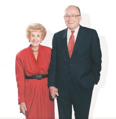 E.L. and Thelma Gaylord stand holding hands