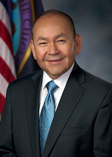Photo of Governor Bill Anoatubby, a man wearing a suit with a blue tie