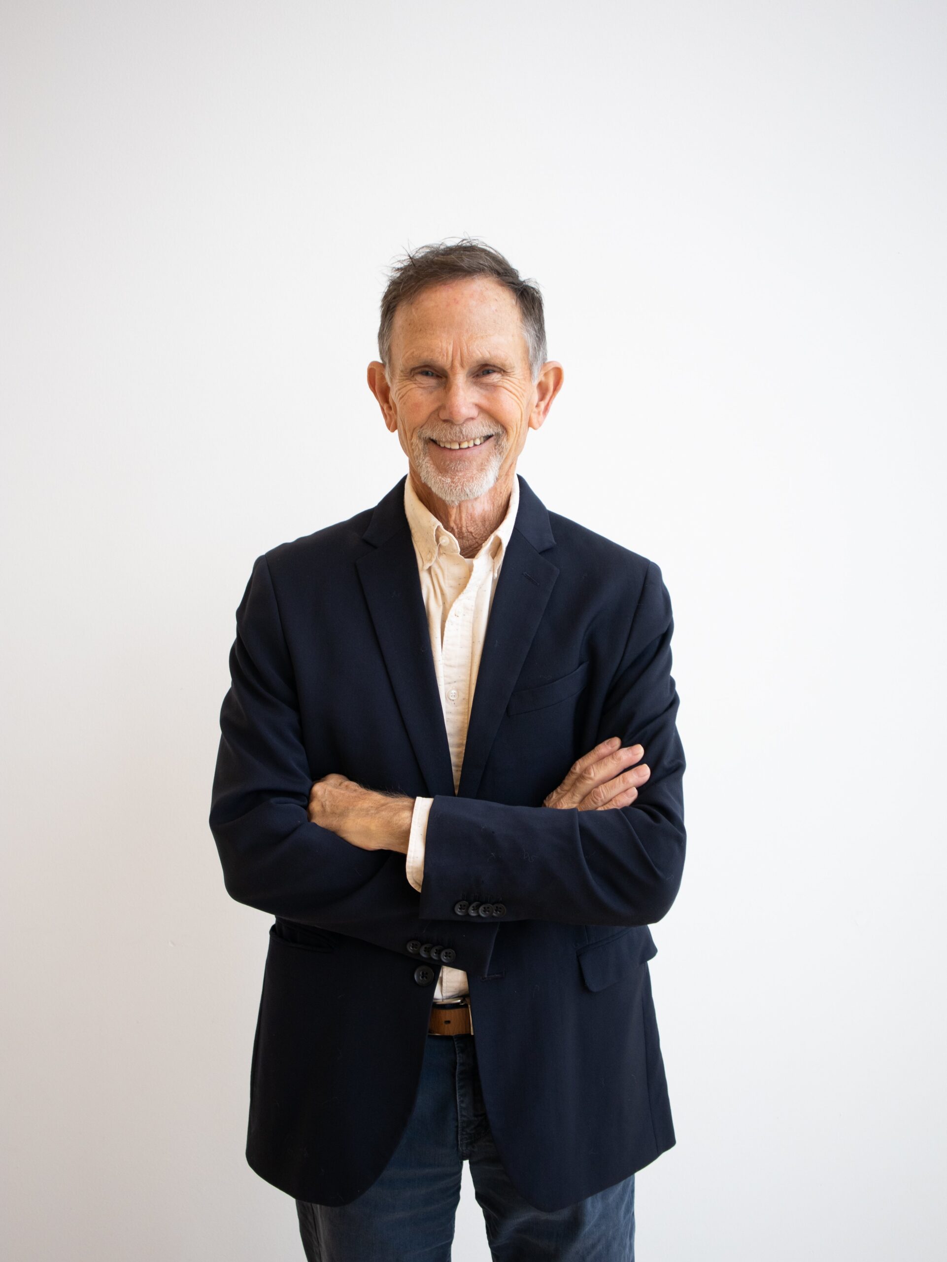 Randy Marks, a man in a sport coat, stands with his arms crossed