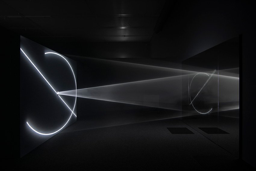 "Solid light" sculptures in a hazy room