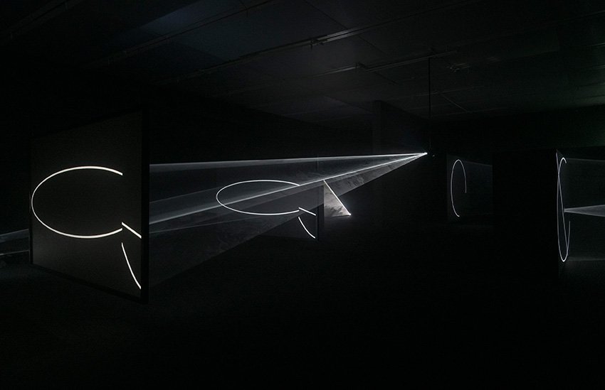 "Solid light" sculptures in a hazy room