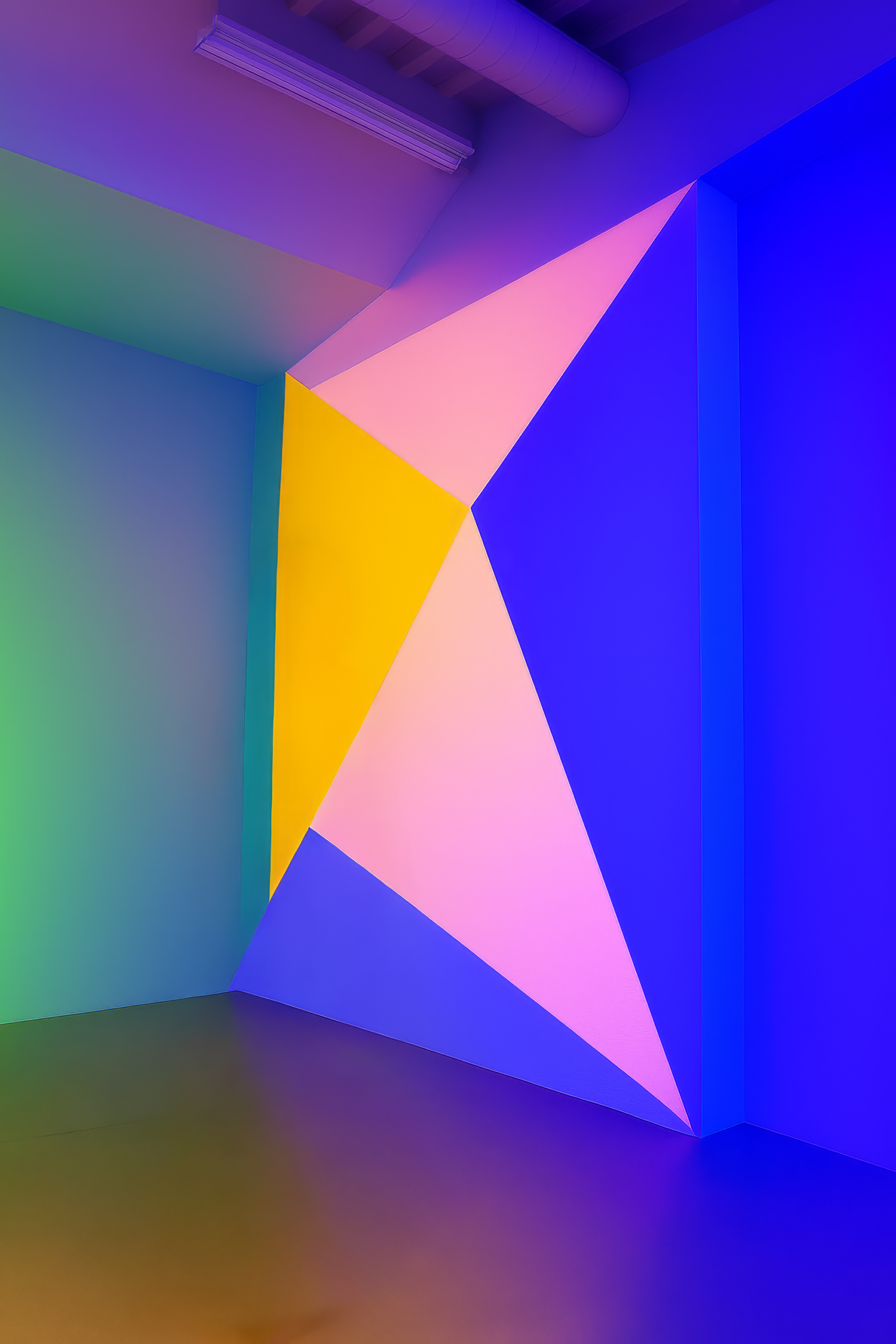 Brightly colored lights form geometric patterns on a wall