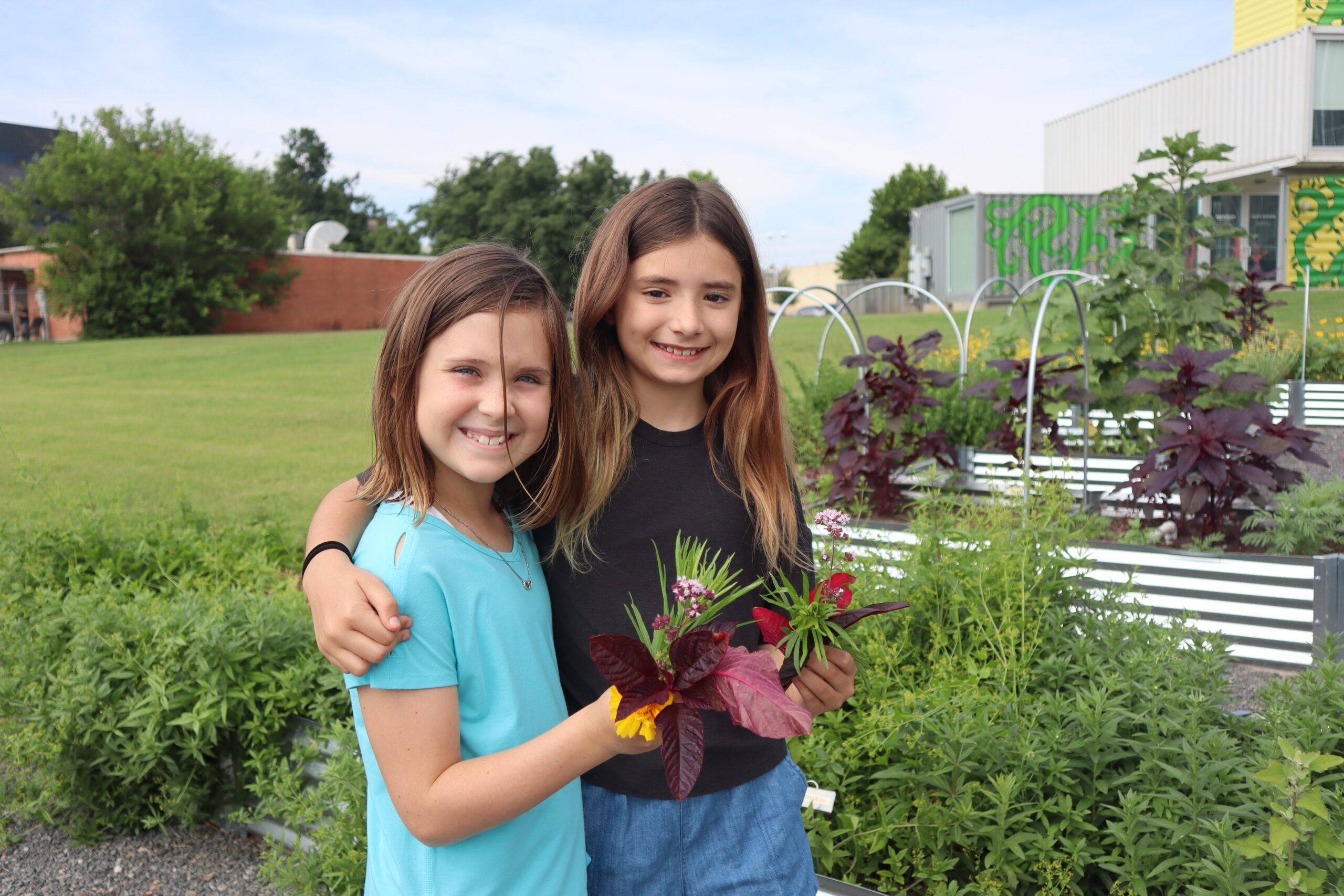 Two girls stand in the Art Garden at Oklahoma Contemporary