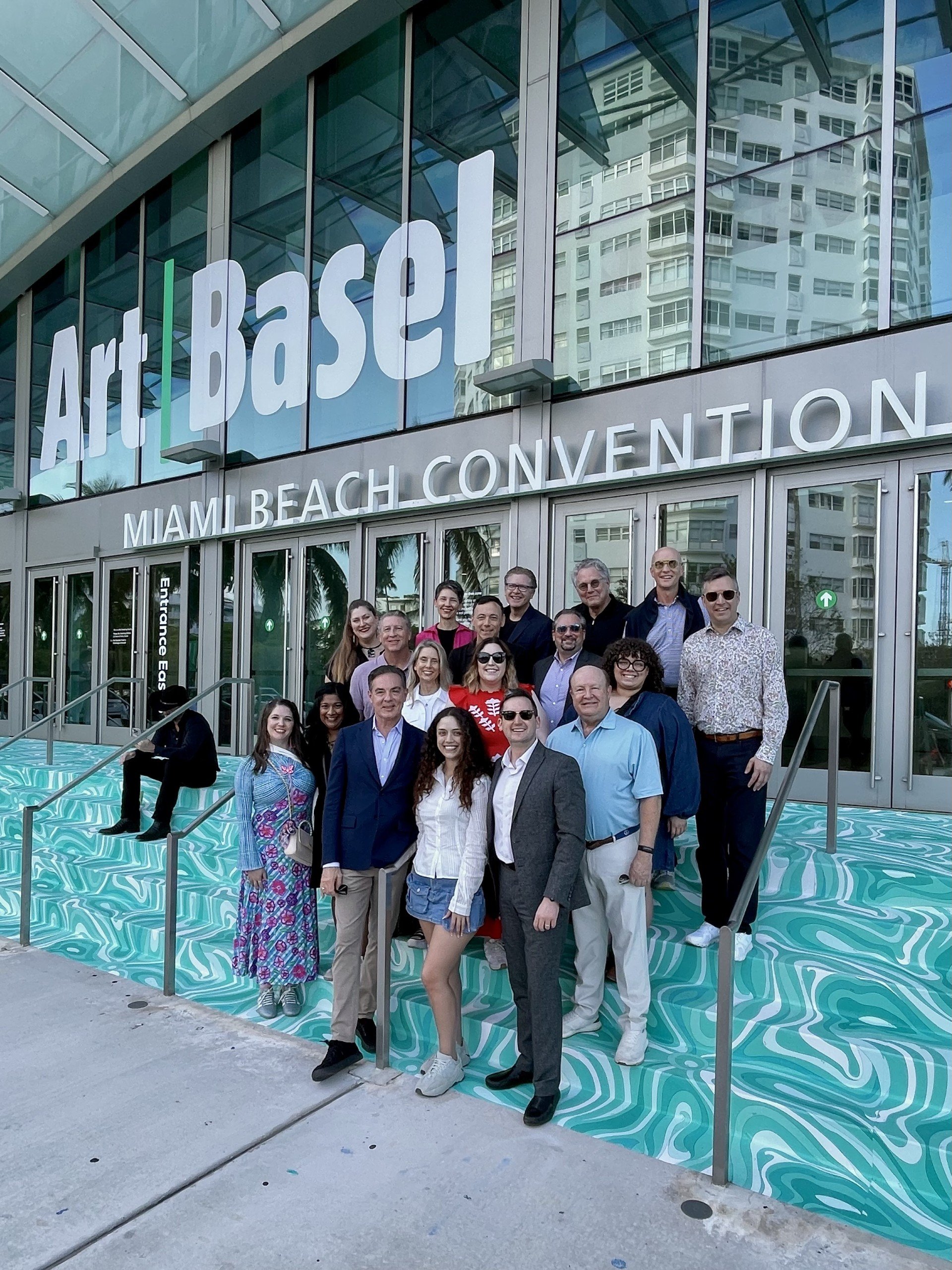 A group of people pose outside the Miami Beach Convention Center at an Art Basel event