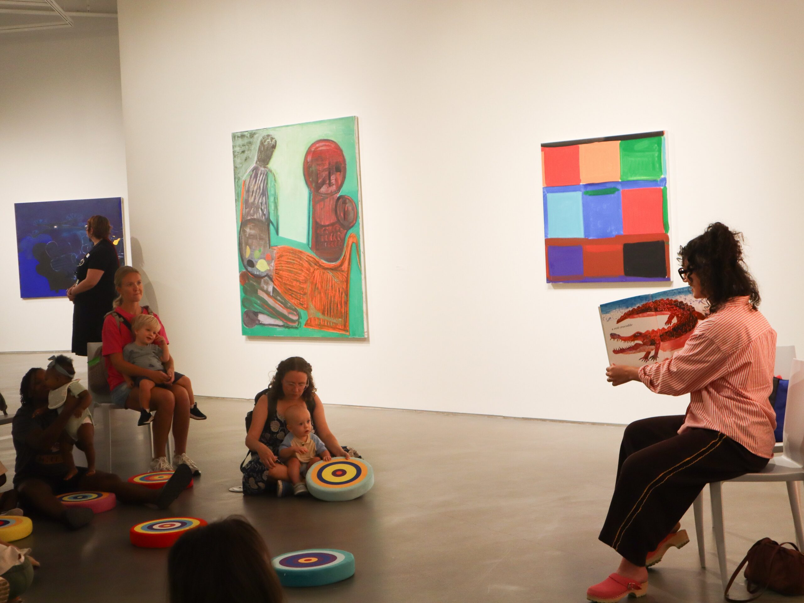 Person reads to children in art gallery